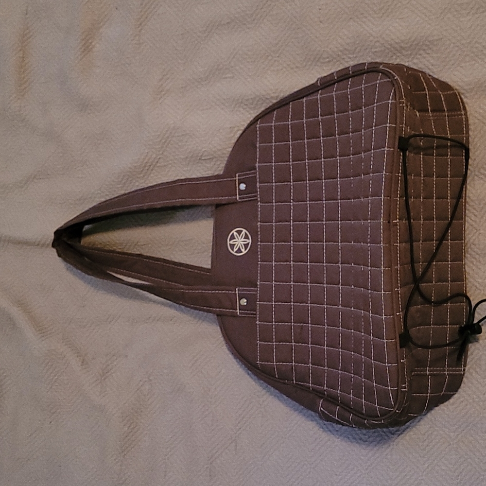 Brown gym bag with yoga straps